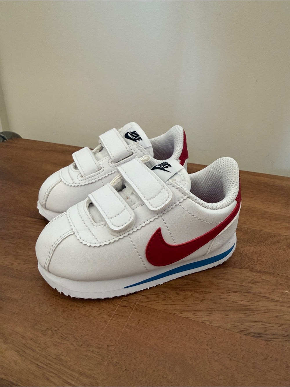 Nike Kids White Sneakers with Red Swoosh and Blue Accent